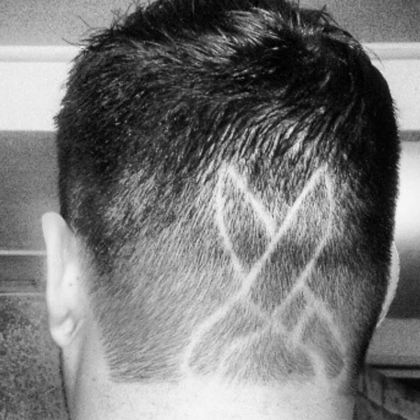 Crossed chef&rsquo;s knives, razored freehand into his haircut
